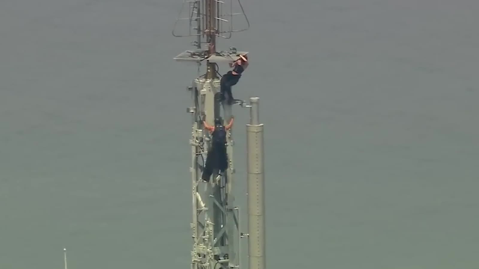 A still from news footage of the couple who climbed the Empire State Building's antenna without permission